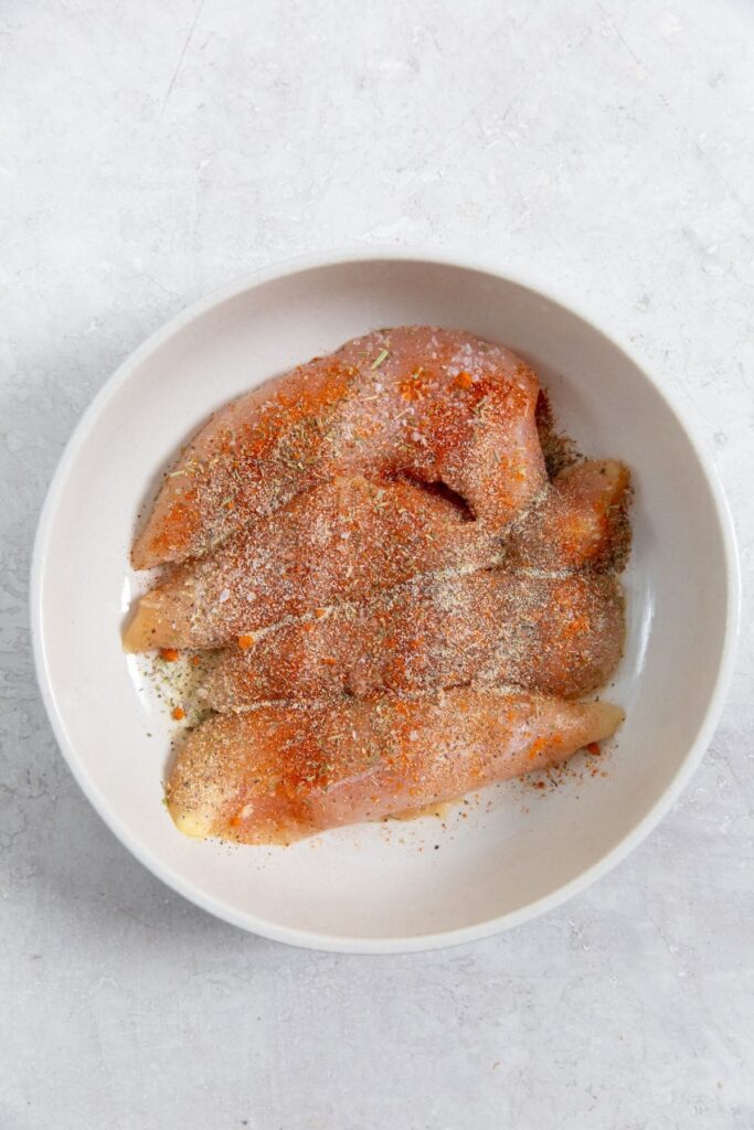 Air Fryer Blackened Chicken Tenders white bowl with chicken tenders
