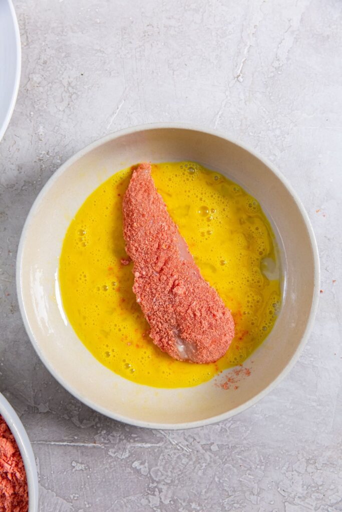 Air Fryer Flamin' Hot Cheetos Chicken Tenders chicken inside the egg wash