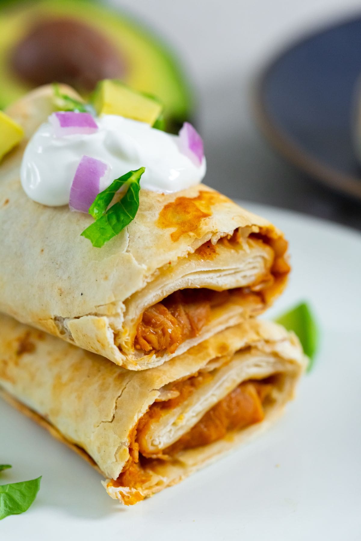 Air Fryer Trader Joes Chicken Burritos burrito with sour cream avocado and lettuce