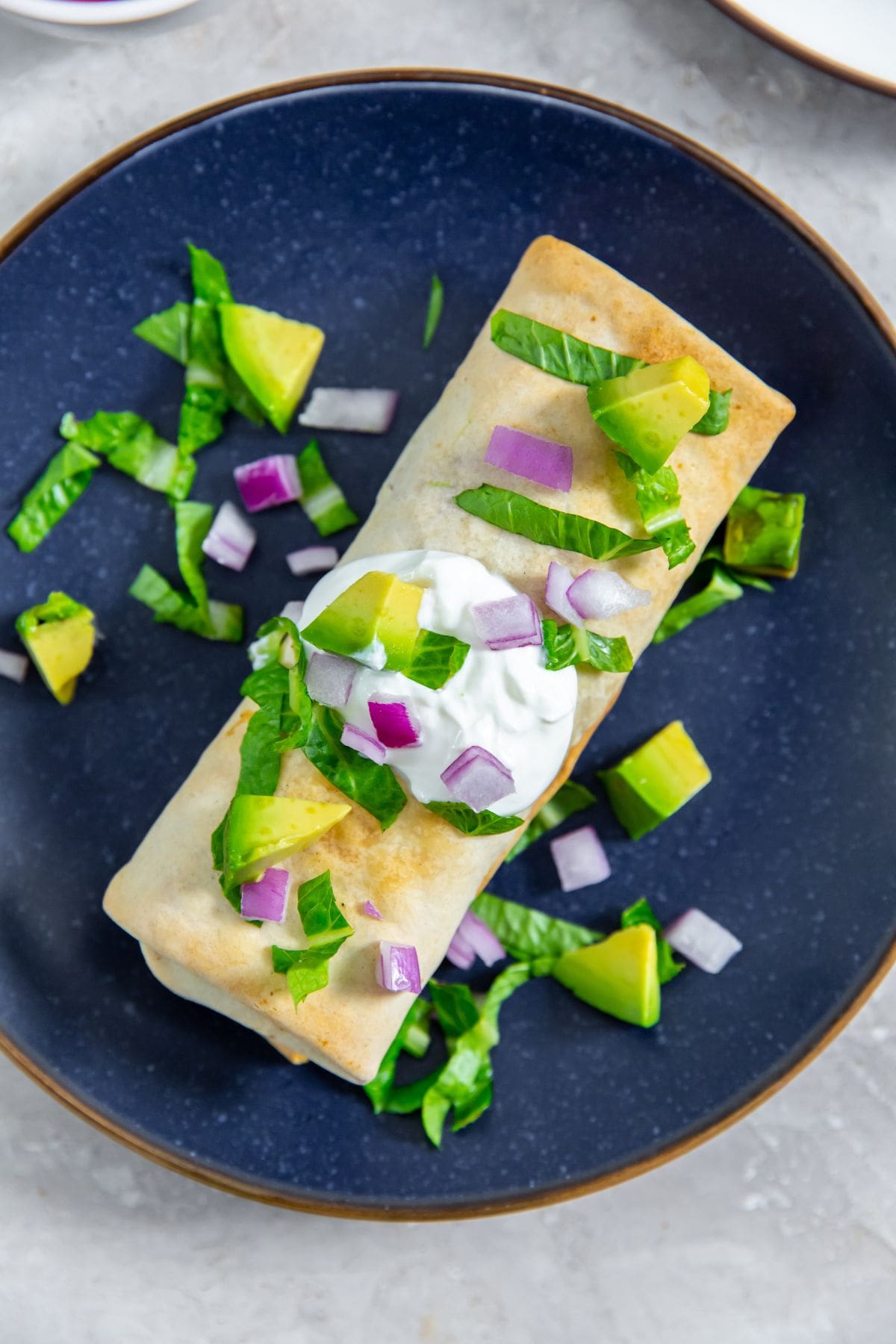 Air Fryer Trader Joes Chicken Burritos burrito with sour cream avocado and lettuce