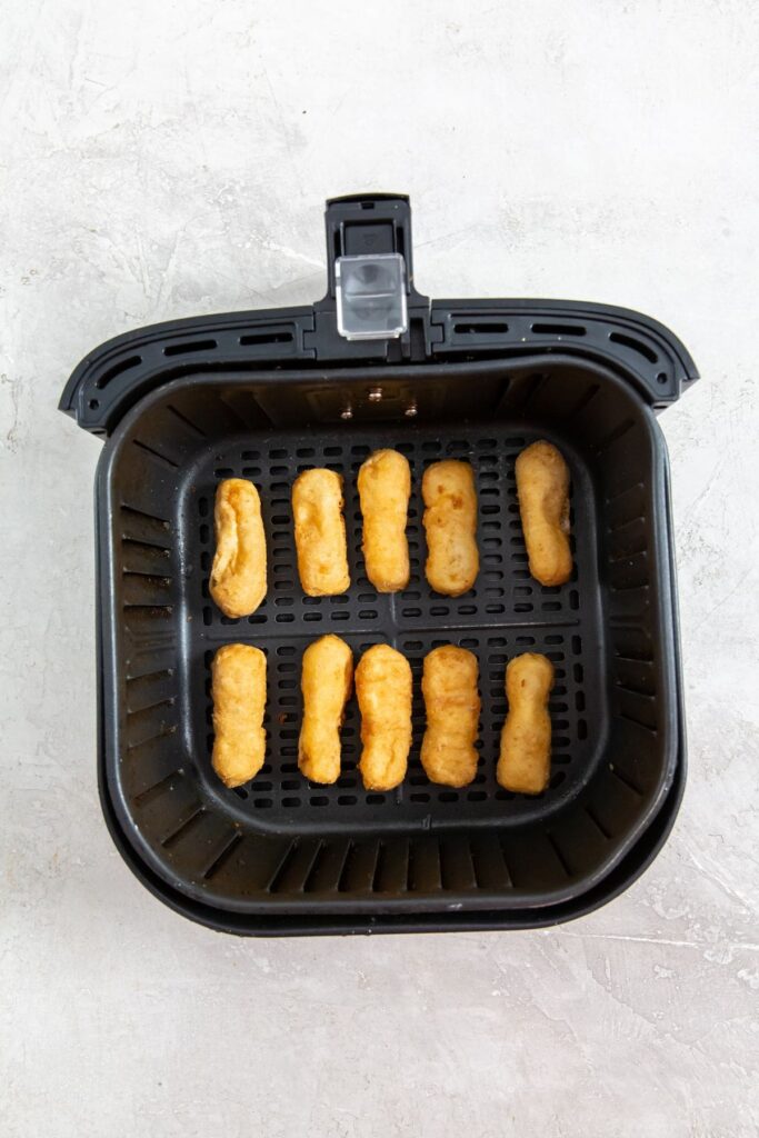 Air Fryer Tyson Honey Battered Breast Tenders black air fryer with raw chicken inside
