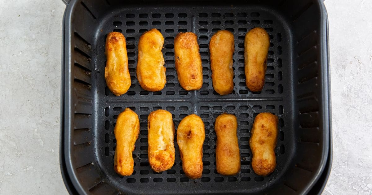 Air Fryer Tyson Honey Battered Breast Tenders black air fryer basket with cooked chicken inside