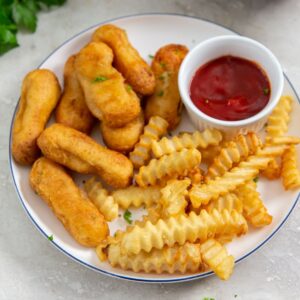 Air Fryer Tyson Honey Battered Breast Tenders a Plate of Chicken Tenders with Crinkle Fries, and a Small Ramekin of Ketchup