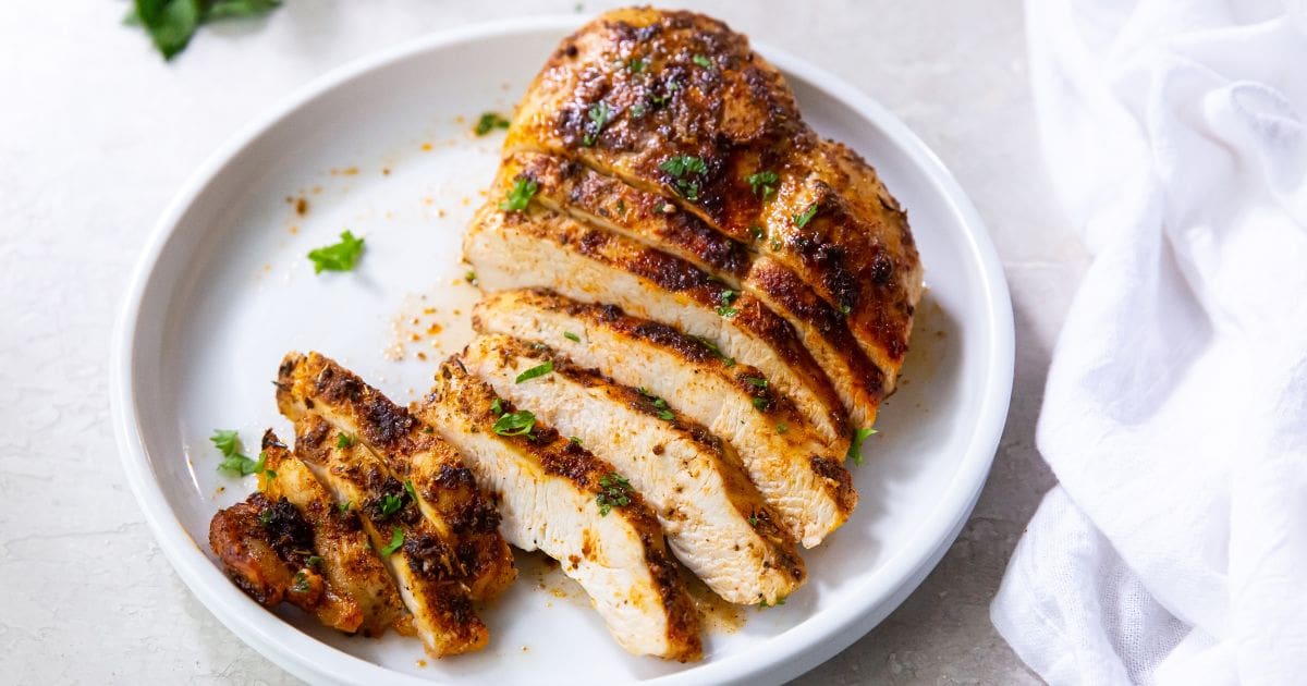 Air Fryer Blackened Chicken Breast blackened chicken breast cut up on a white plate