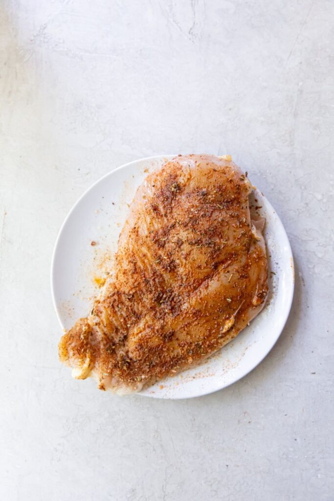 Air Fryer Blackened Chicken Breast raw chicken breast with seasonings rubbed onto it