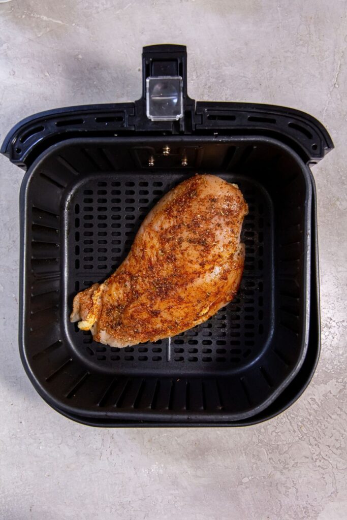 Air Fryer Blackened Chicken Breast Black Air Fryer with raw chicken inside