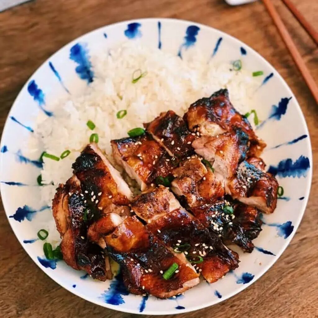Air Fryer Chicken Marinades a Bowl of Rice Topped with Sliced Soy Sauce Chicken