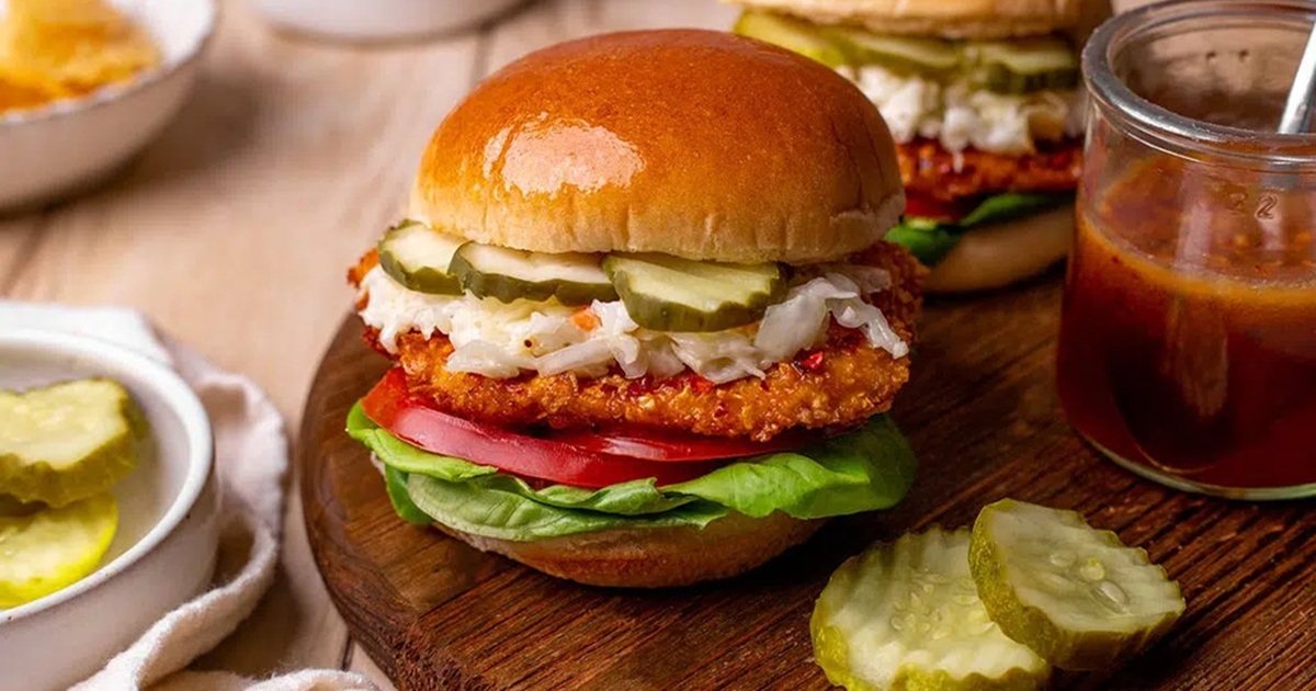 Air Fryer Chicken Sandwich Recipes Air Fryer Hot Honey Chicken Sandwiches with Pickles on the Side on a Wooden Plate