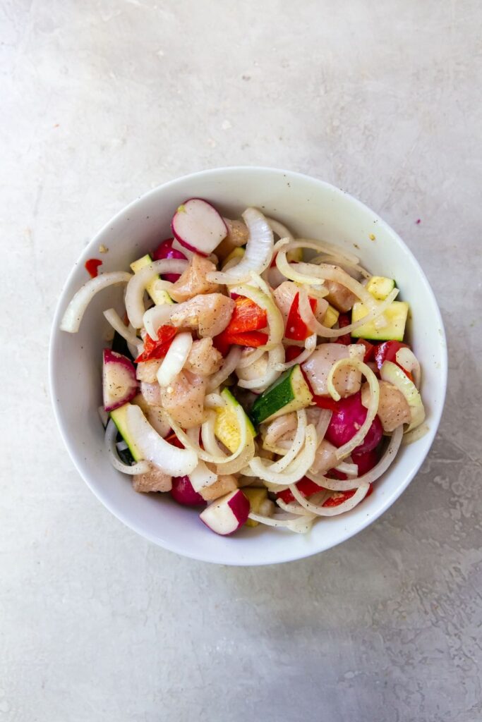 Air Fryer Chicken and Veggies White bowl with chicken and veggies mixed together