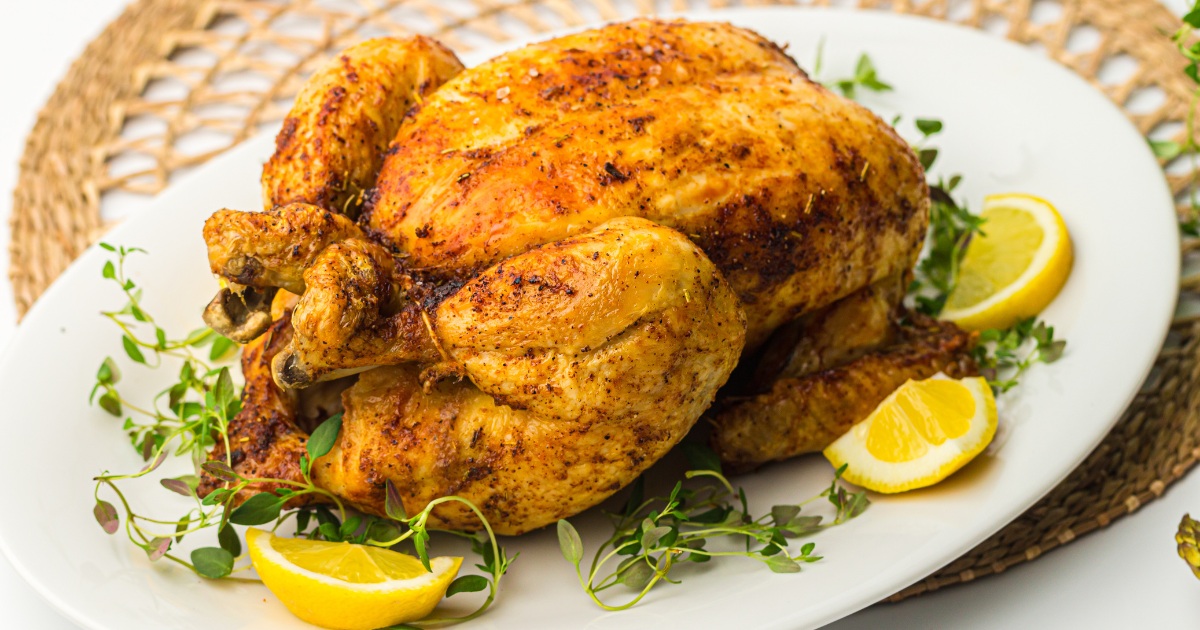 Air Fryer Whole Chicken Recipes Close Up of Air Fryer Whole Chicken on a Serving Platter with Lemon Slices