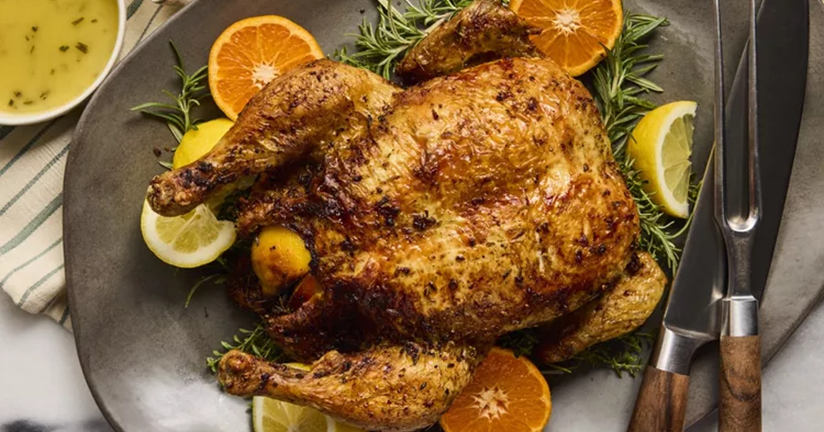 Air Fryer Whole Chicken Recipes Air Fryer Roast Chicken with Rosemary-Orange Sauce on a Platter with Orange Slices