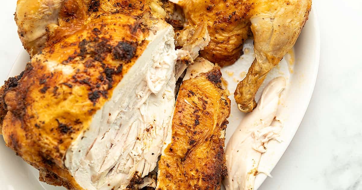 Air Fryer Whole Chicken Recipes Rotisserie-Style Air Fryer Whole Chicken on a Serving Platter with a Slice Cut Form the Breast