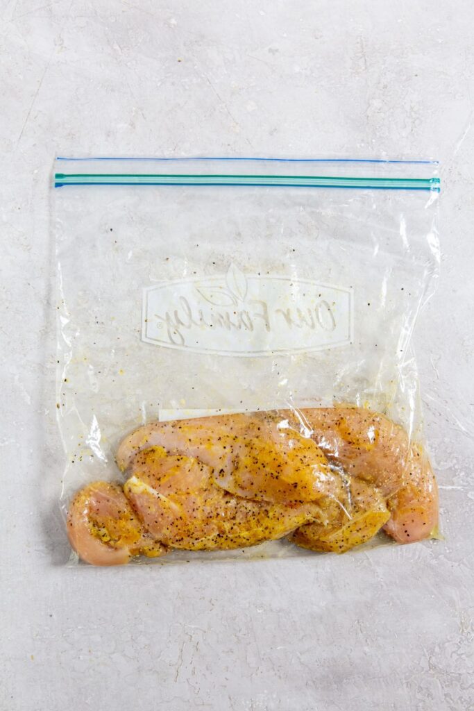 Air Fryer Lemon Pepper Chicken Tenders ziplock bag with seasoned chicken inside