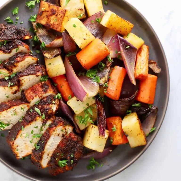 One-Pan Air Fryer Chicken and Veggie Recipes Spiced Chicken Sliced on a Plate with Veggies