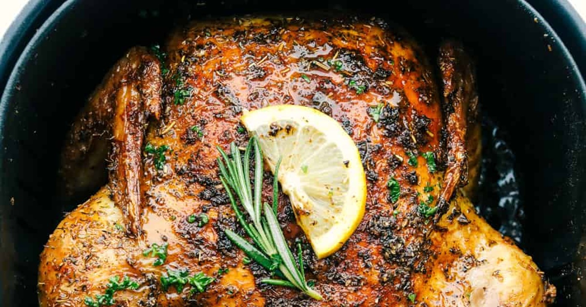 Air Fryer Whole Chicken Recipes Air Fryer Whole Chicken in an Air Fryer Basket with a Lemon Slice and Thyme