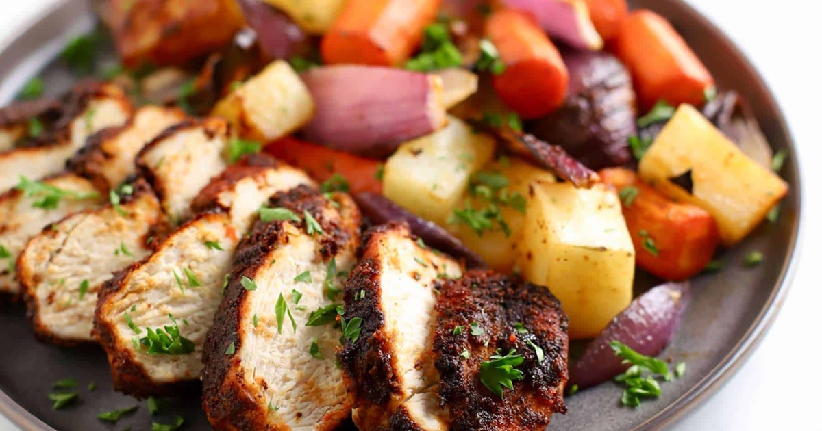 One-Pan Air Fryer Chicken and Veggie Recipes Air Fryer Spiced Chicken and Vegetables Sliced on a Plate