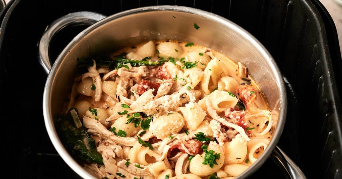Air Fryer Chicken Soup a Silver Pot of Air Fryer Marry Me Chicken Soup in an Air Fryer Basket