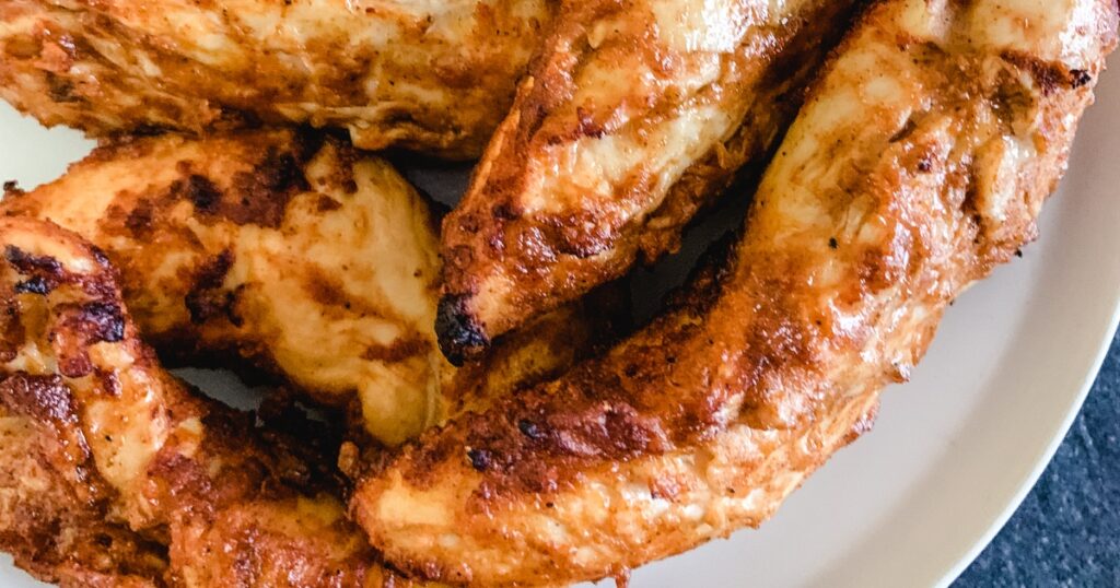 Air Fryer Chicken Taco Recipes Close Up of Cooked Chicken Tenders on a White Plate