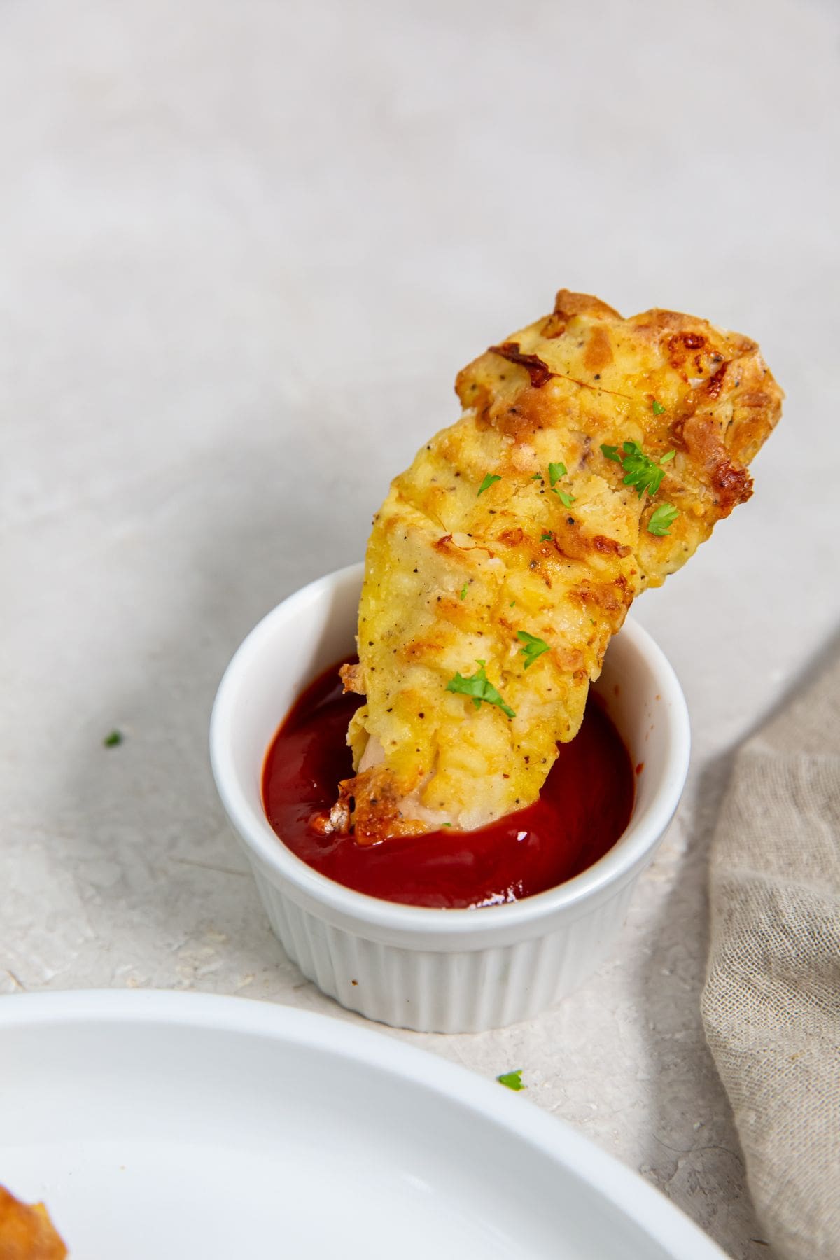 Easy Air Fryer Chicken Tenders With Flour chicken dipped in ketchup