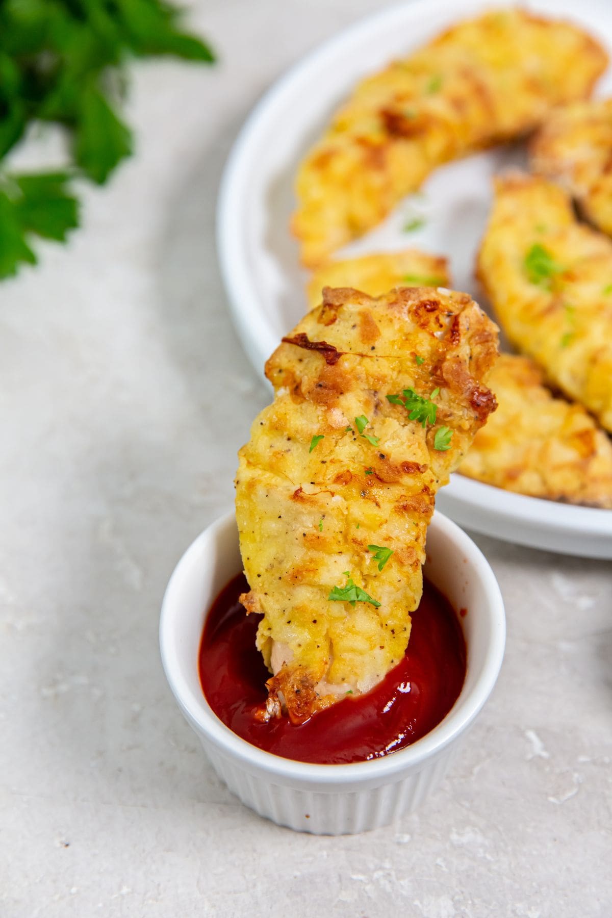 Easy Air Fryer Chicken Tenders With Flour chicken dipped in ketchup