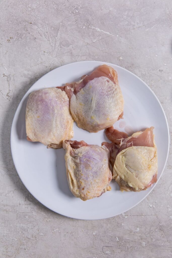 Air Fryer Blackened Chicken Thighs white palate with chicken on it