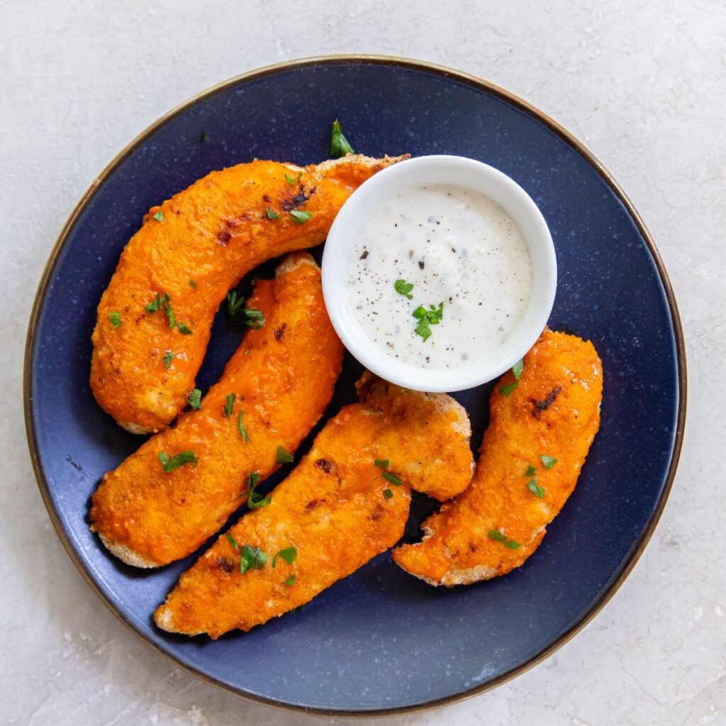 Air Fryer Buffalo Chicken Tenders air fryer buffalo chicken tenders on a blue plate with ranch dressing