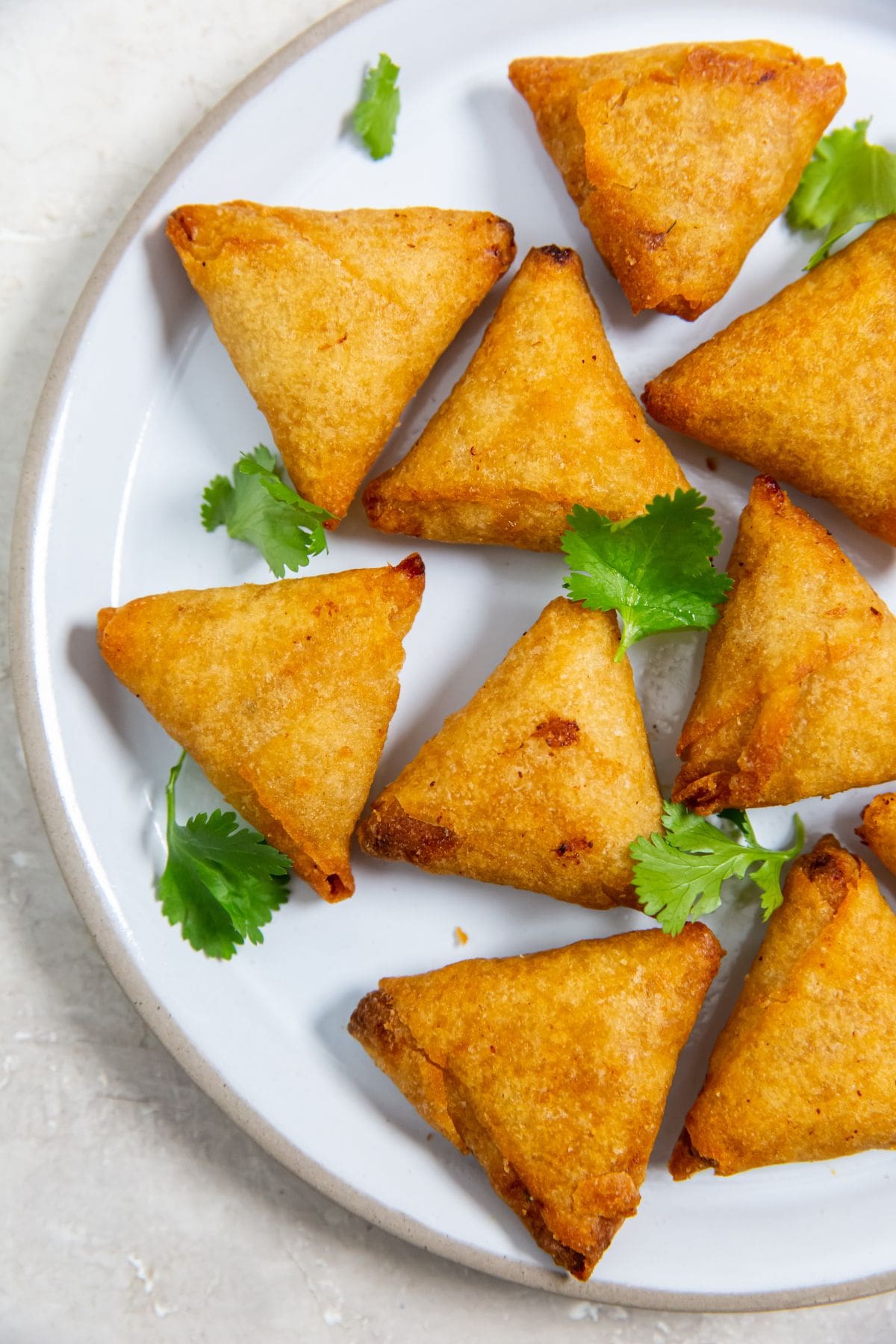 Air Fryer Mini Chicken Tikka Samosas Tikka Samosas served on a white plate.