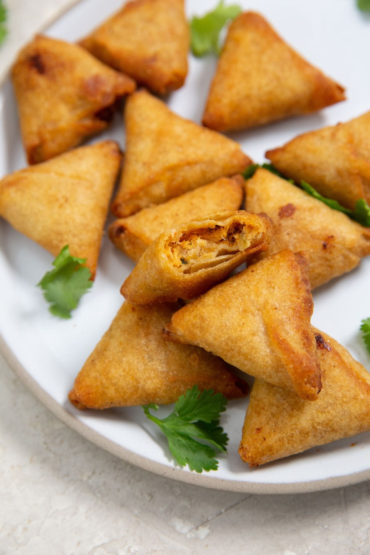 Air Fryer Mini Chicken Tikka Samosas Mini Chicken Samosas on a white plate.