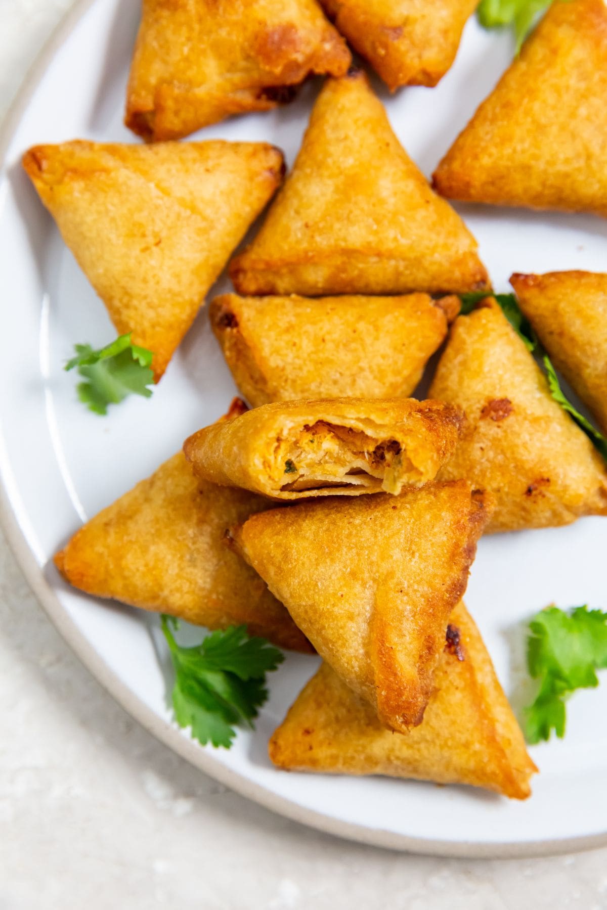 Air Fryer Mini Chicken Tikka Samosas Chicken Tikka Samosas served on a white plate.