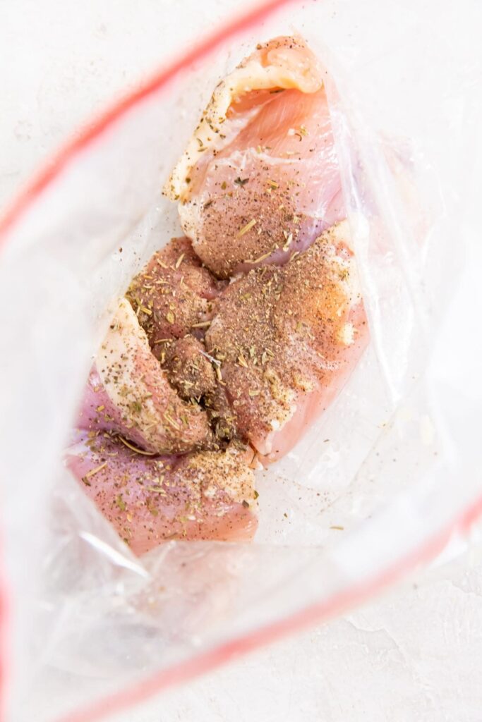 Easy Air Fryer Boneless Skinless Chicken Thighs ziplock bag with seasoned chicken inside