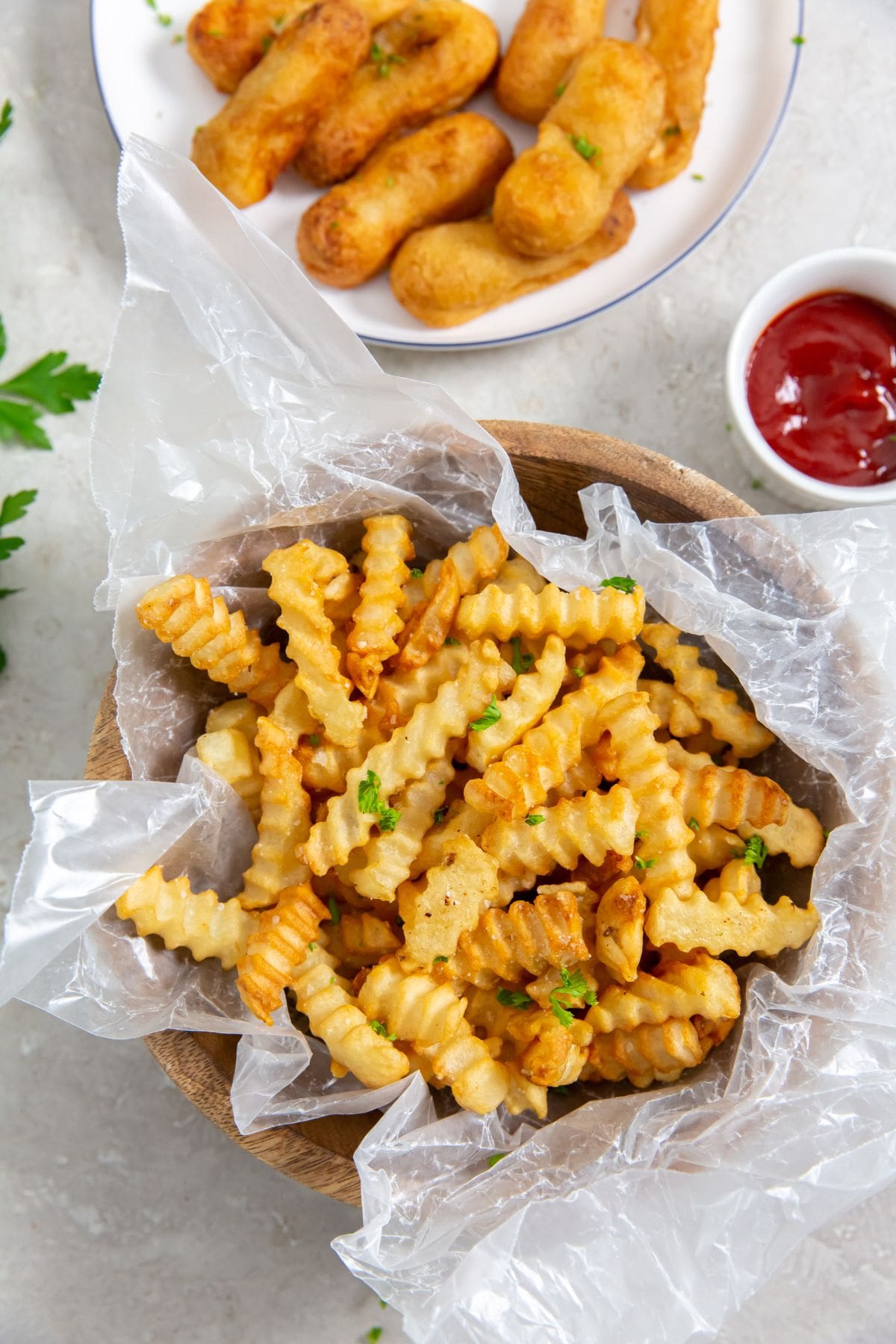 Air Fryer Crinkle Cut French Fries French Fries cooked in an Air Fryer, served in a bowl with ketchup.