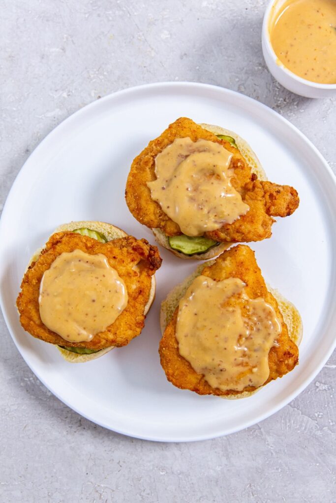 CopyCat Chick-fil-A Sandwich A plate with three chicken Sandwiches.