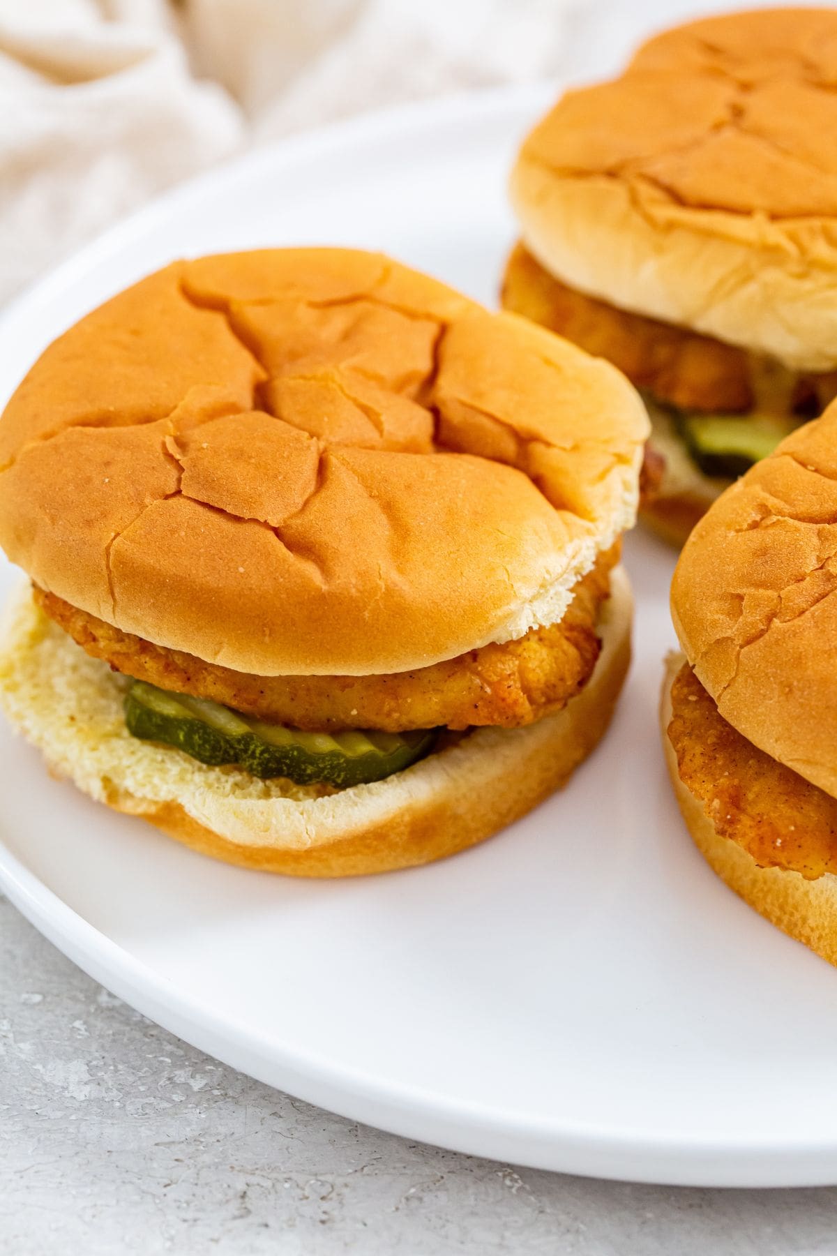 CopyCat Chick-fil-A Sandwich chicken Sandwiches arranged on a white plate.