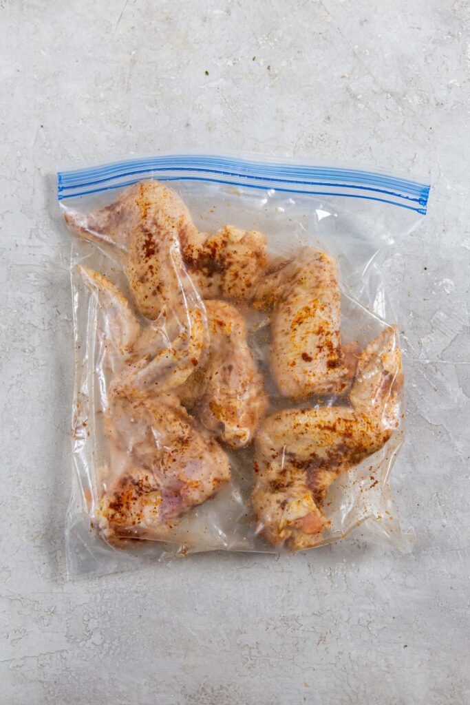 Air Fryer Whole Chicken Wings ziplock bag with seasoned chicken wings inside