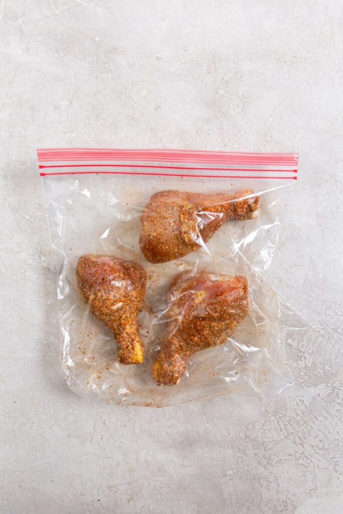 Easy Air Fryer Chicken Legs with Dry Rub ziplock bag with chicken tossed inside