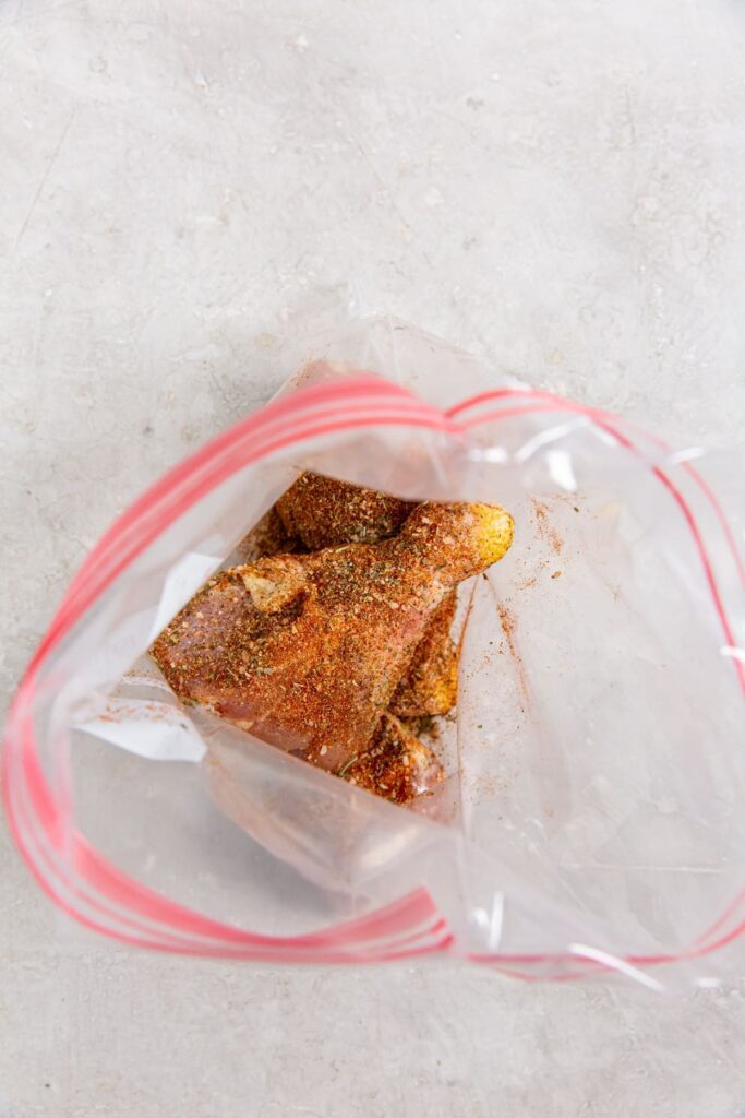Easy Air Fryer Chicken Legs with Dry Rub ziplock bag with chicken and seasoning inside