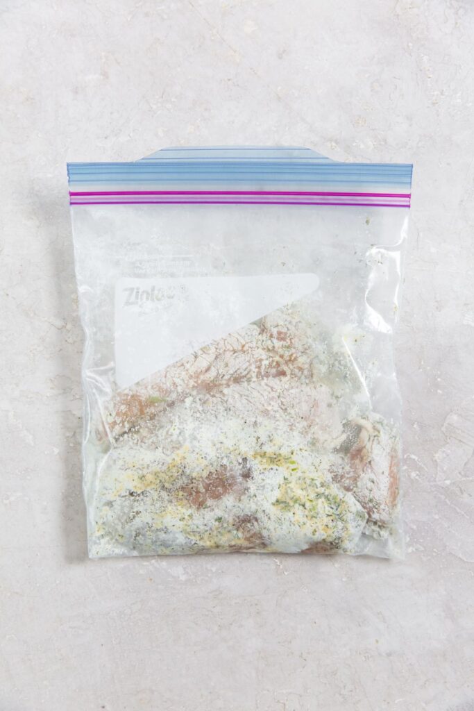 Air Fryer Ranch Chicken Tenders raw tenders covered in flour and seasoning in a closed ziplock bag