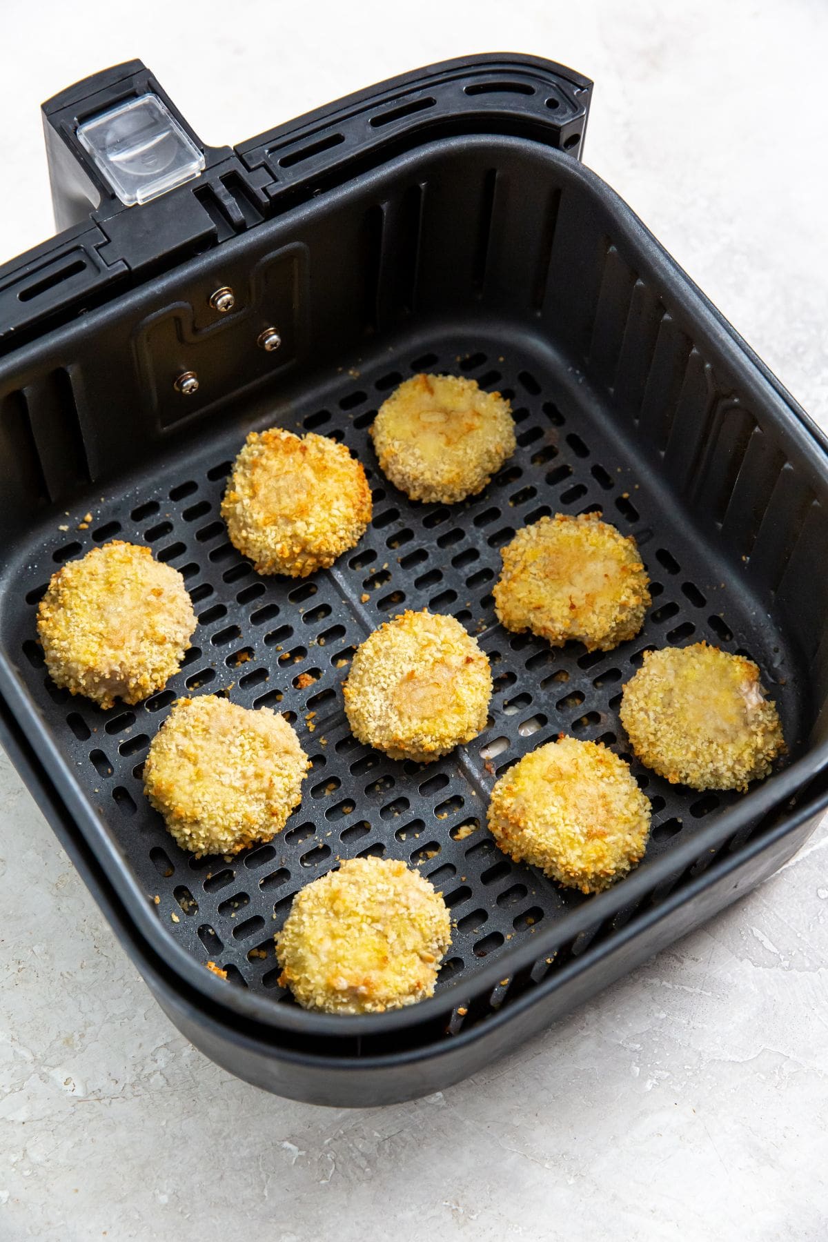 Homemade Air Fryer Chicken Nuggets Recipe black air fryer with cooked chicken inside