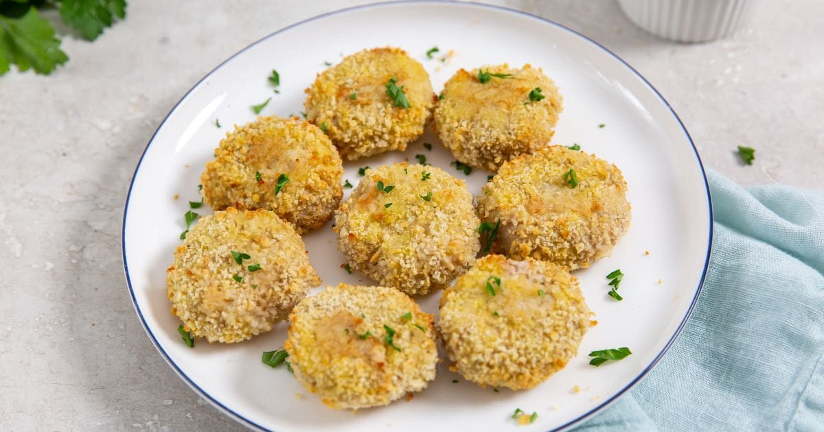Homemade Air Fryer Chicken Nuggets Recipe Nuggets on a white plate sprinkled with parsley