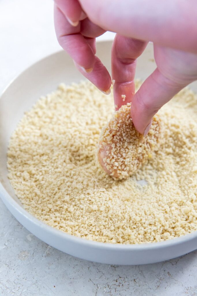 Homemade Air Fryer Chicken Nuggets Recipe bowl of bread crumbs with chicken dunked in bread crumbs