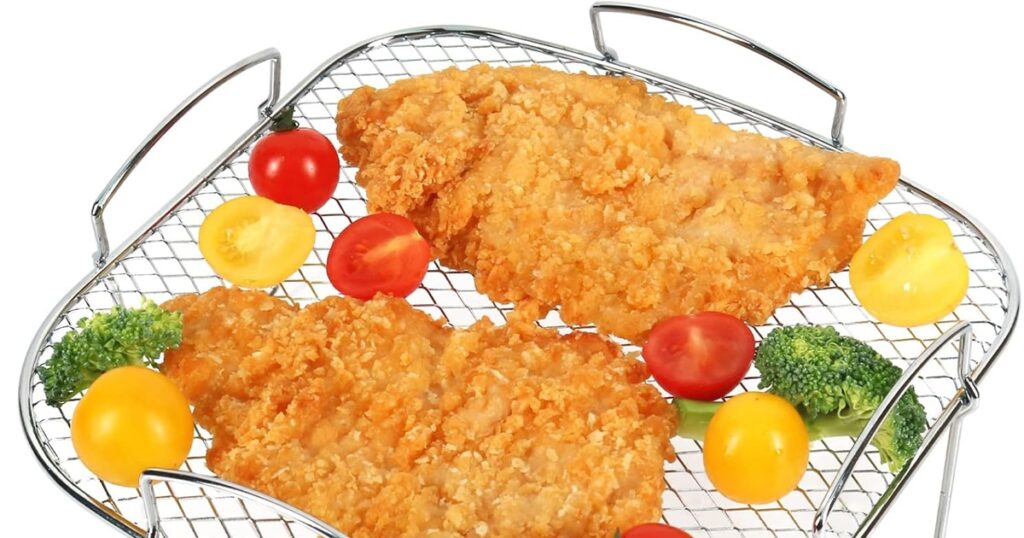 Must-Have Air Fryer Accessories Two Pieces of Fried Chicken with Some Veggies on a Wire Rack